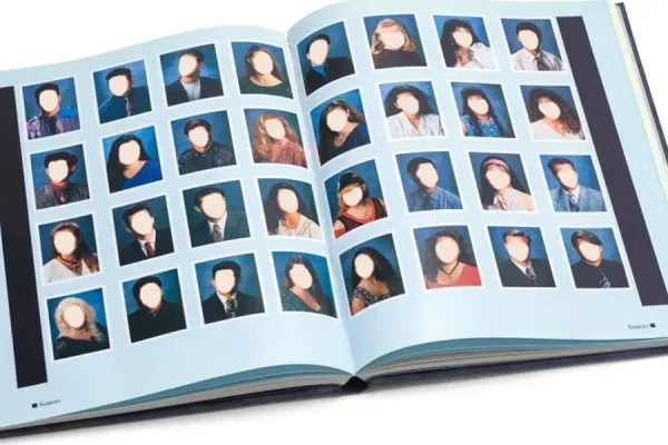 Open school yearbook with student portrait photos